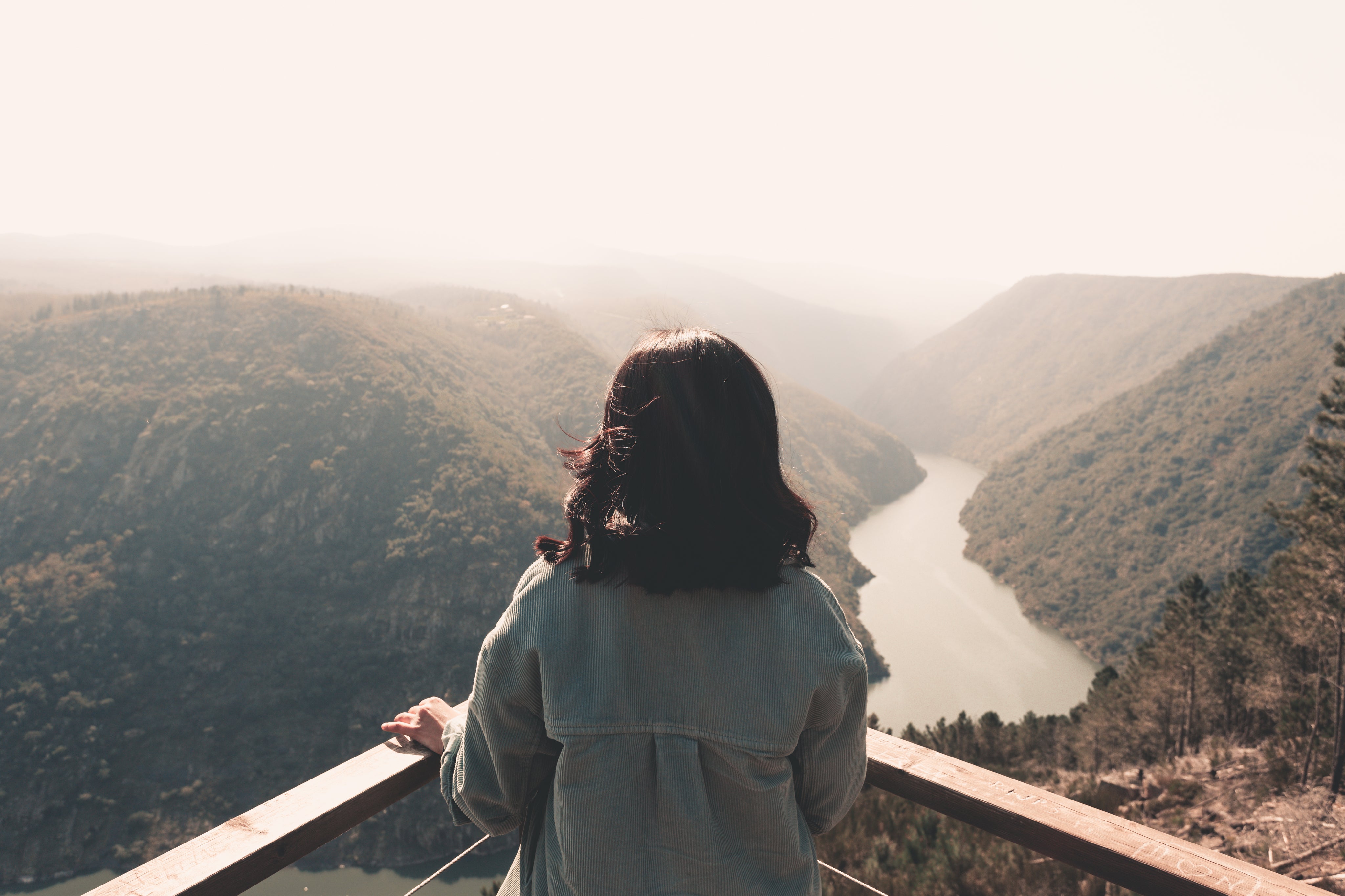 a-person-standing-at-a-corner-taking-in-the-forest-view.jpg